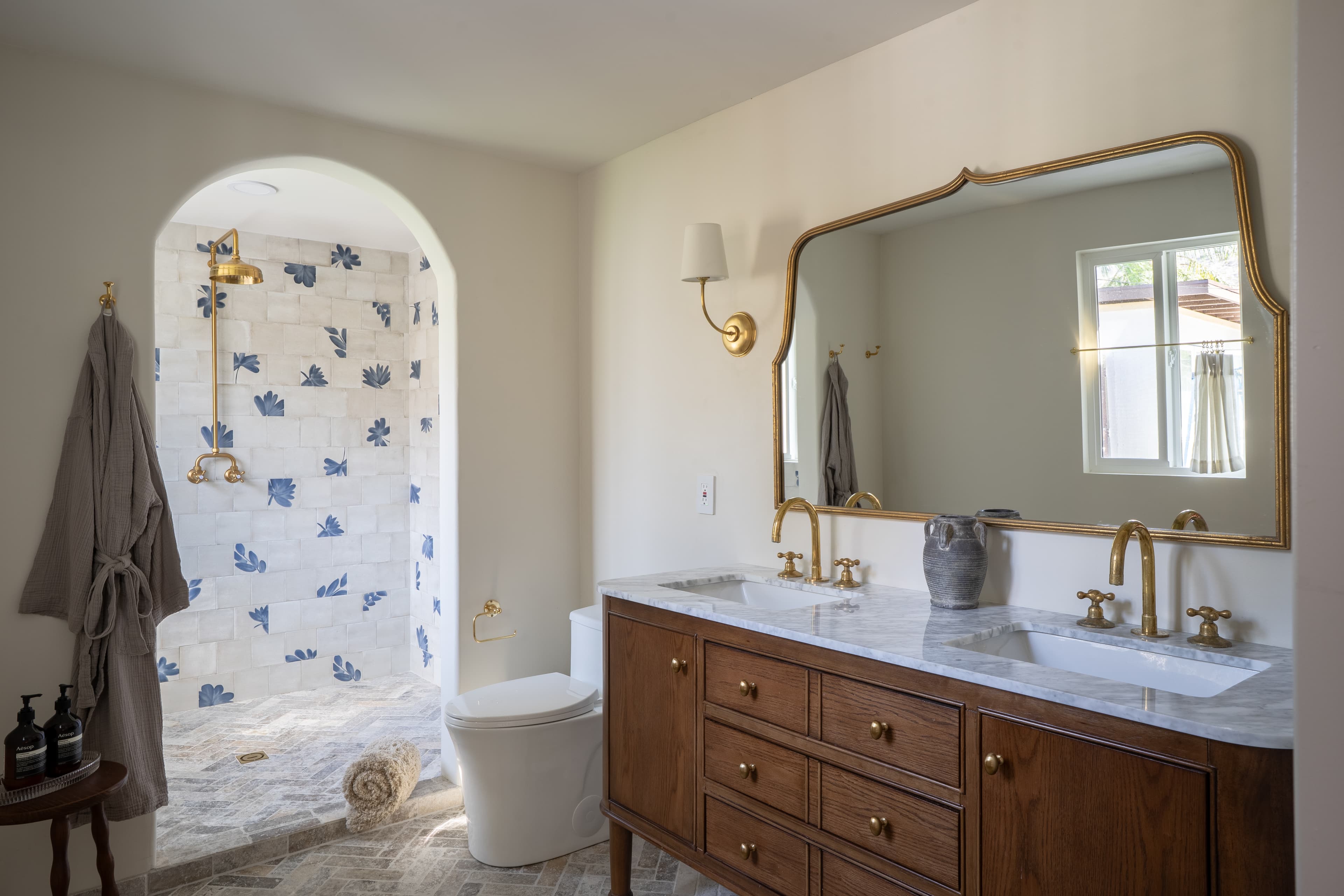 Warm neutral primary bathroom designed by Halcyon Haus