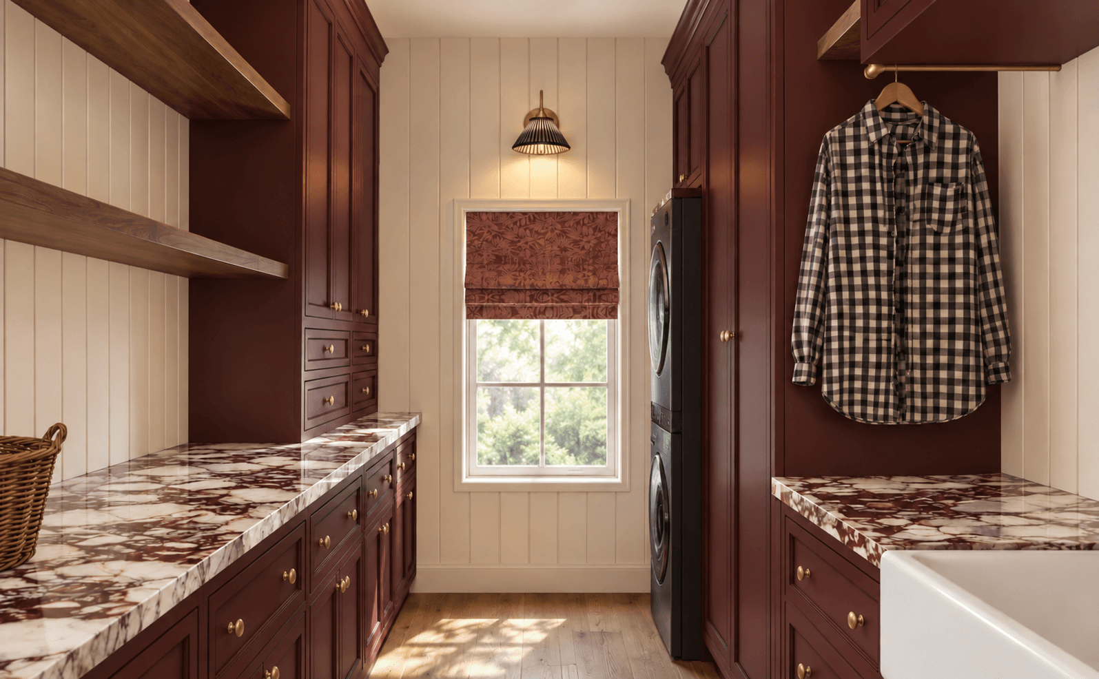 Rendering of the same laundry room with oxblood cabinetry, red-veined stone counters, brass hardware, and a patterned Roman shade, designed by Halcyon Haus