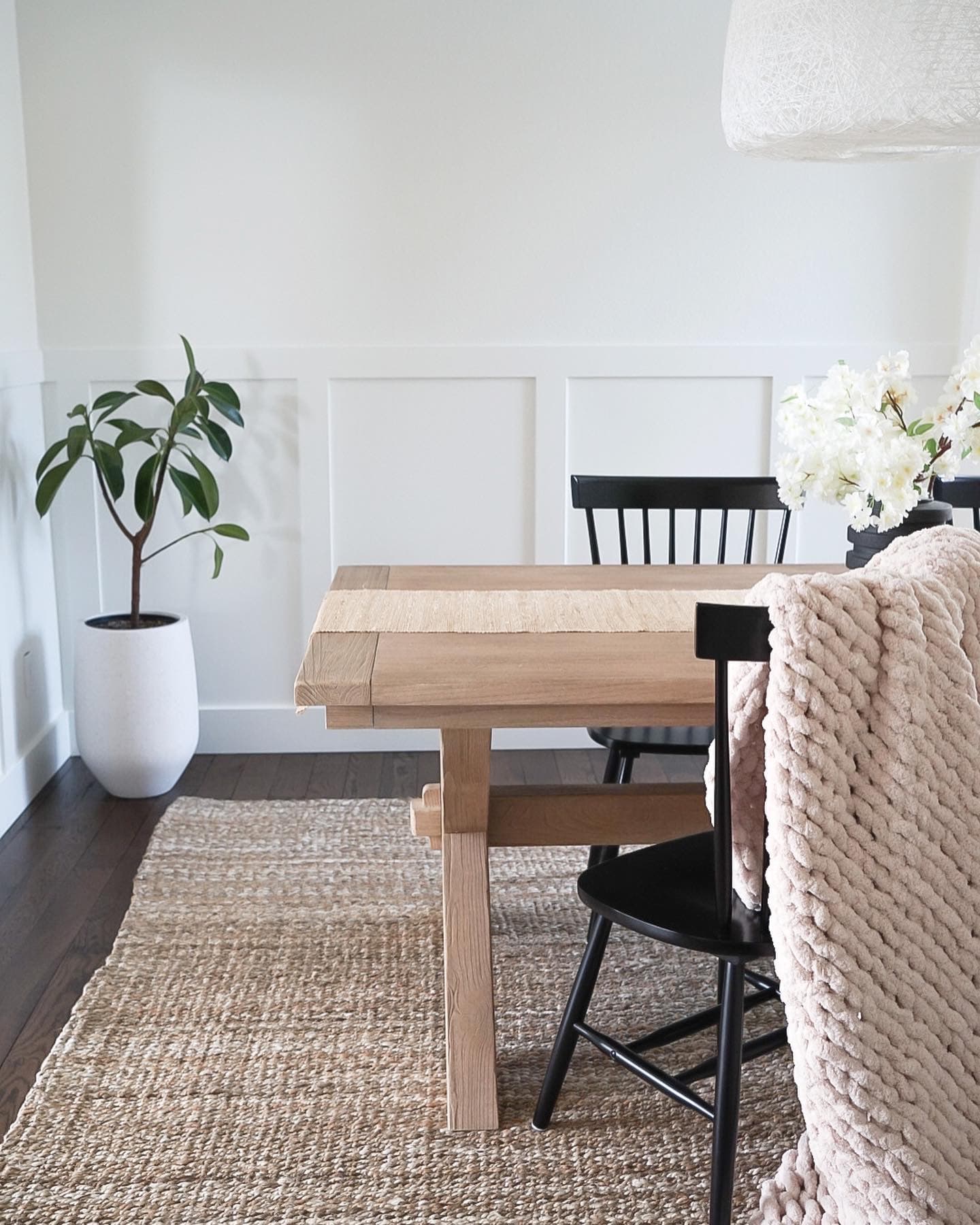 Highlands Ranch dining room with a light wood farmhouse table, black spindle chairs, and a jute rug