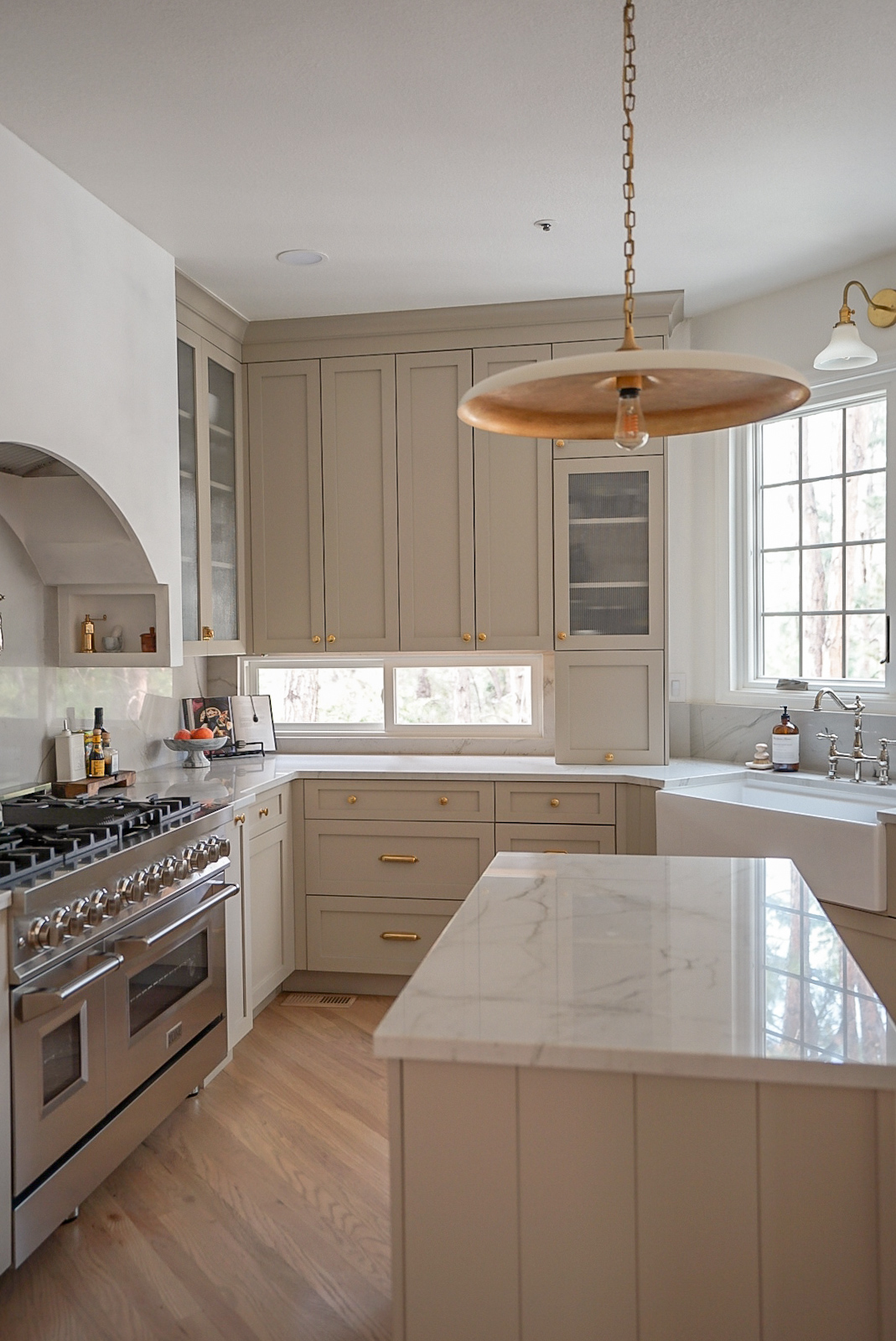 Kitchen angle featuring reeded glass uppers and polished nickel faucet in Colorado interior