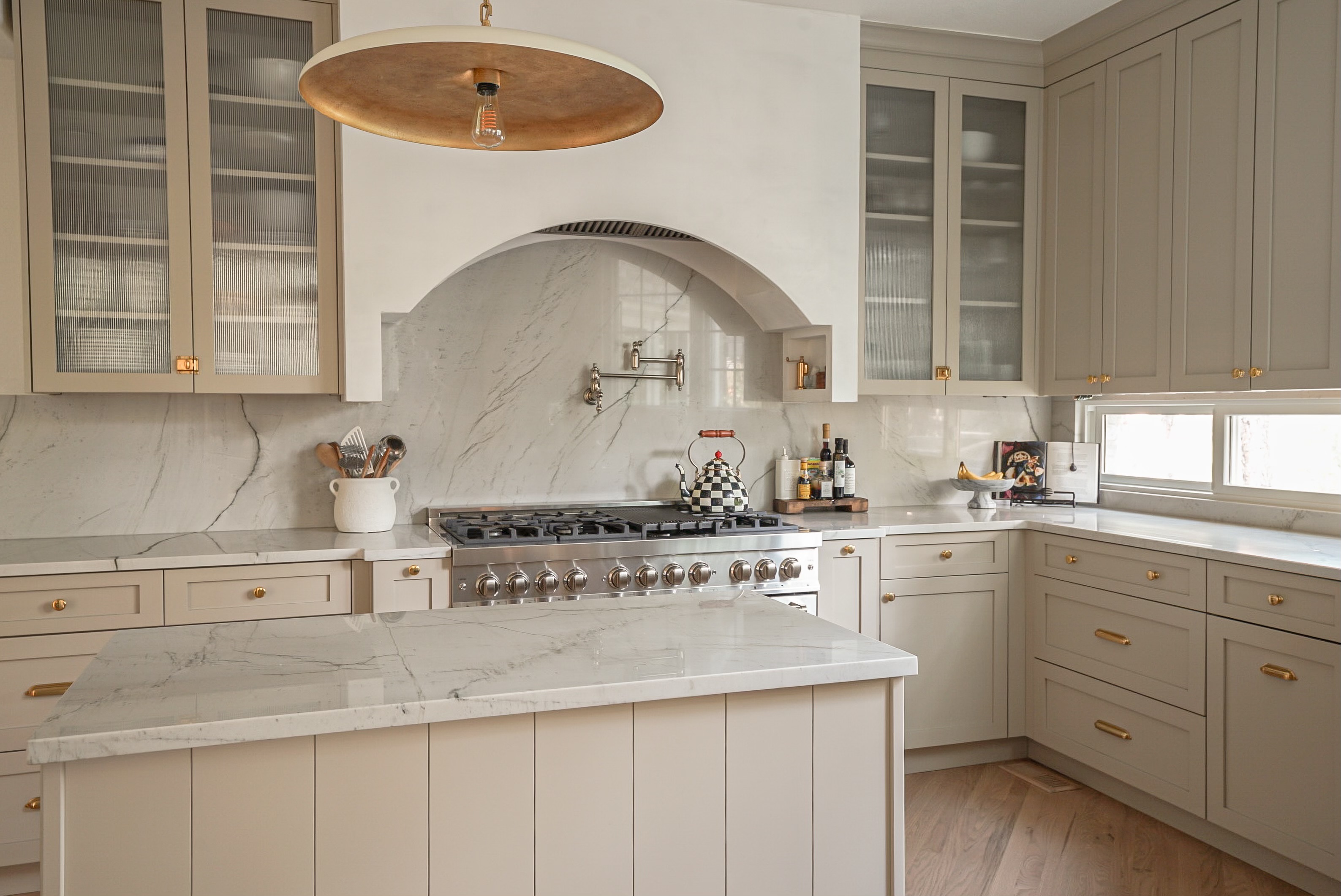Castle Pines kitchen with Benjamin Moore Pashmina cabinets and Venetian plaster range hood by Halcyon Haus