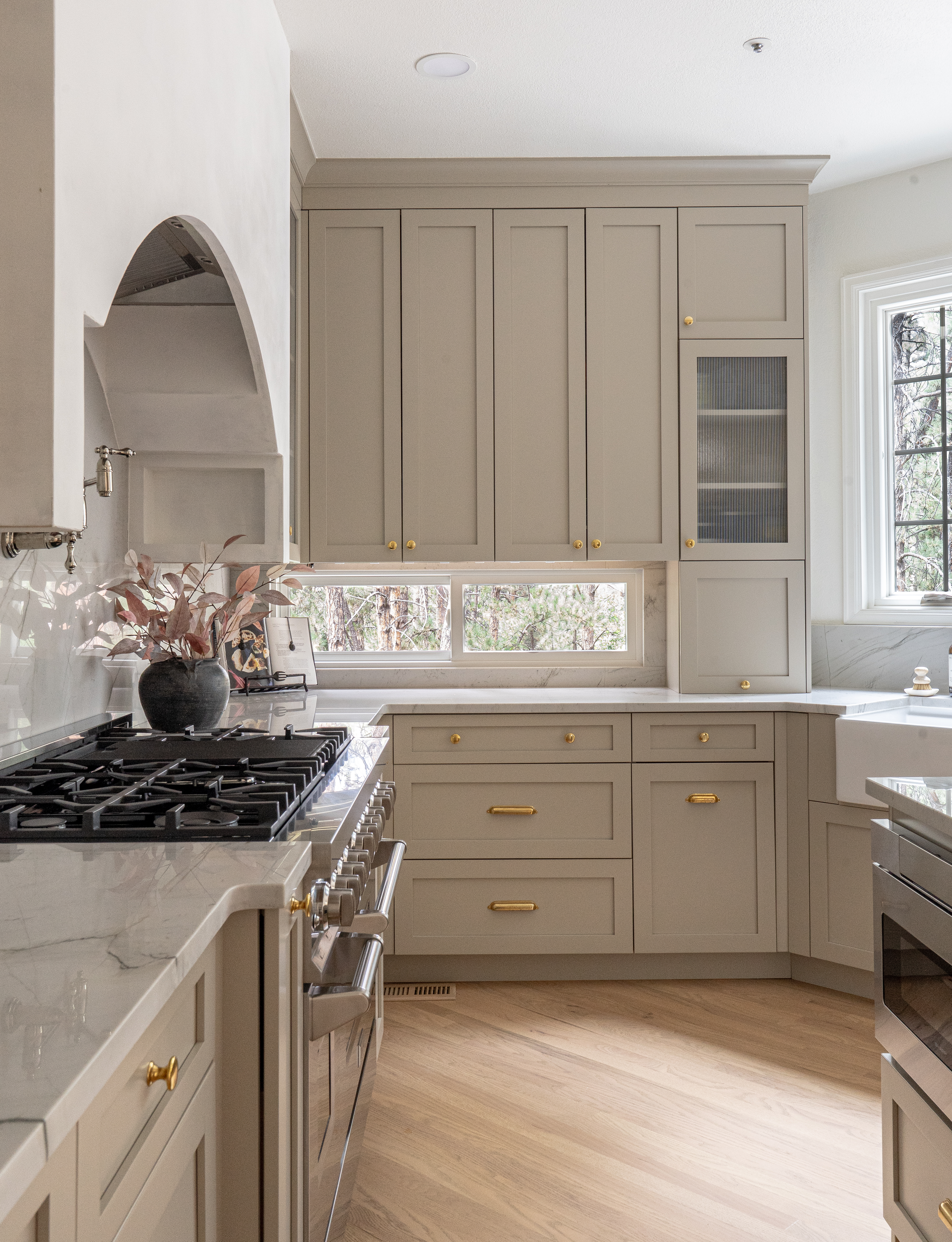Kitchen angle featuring reeded glass uppers and polished nickel faucet in Colorado interior